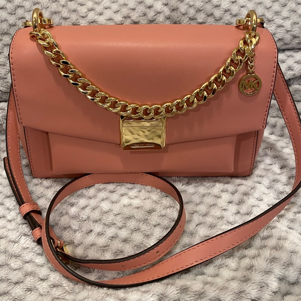 Michael Kors cross body purse in beautiful pink color with gold accents